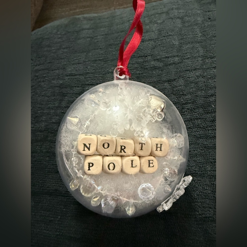 North Pole Holiday Ornament with Red Ribbon